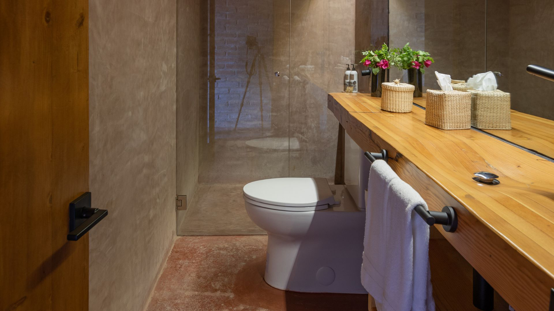 a bathroom with a wood counter and a shower