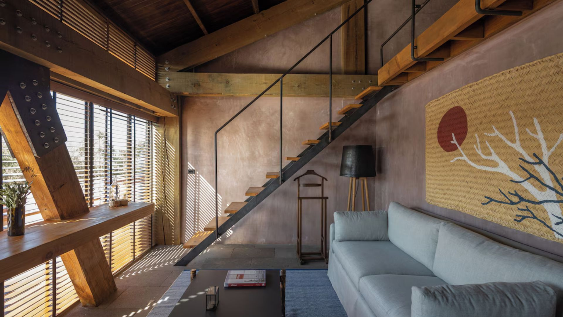 a living room with a staircase and a couch