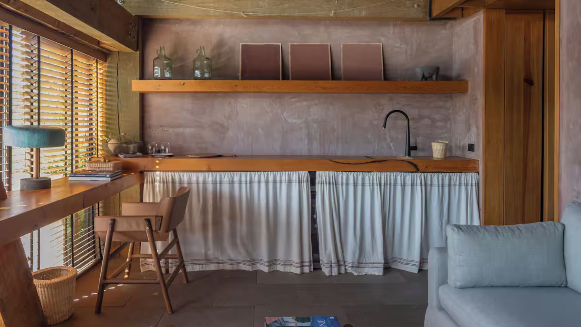 a kitchen with a sink and a white couch