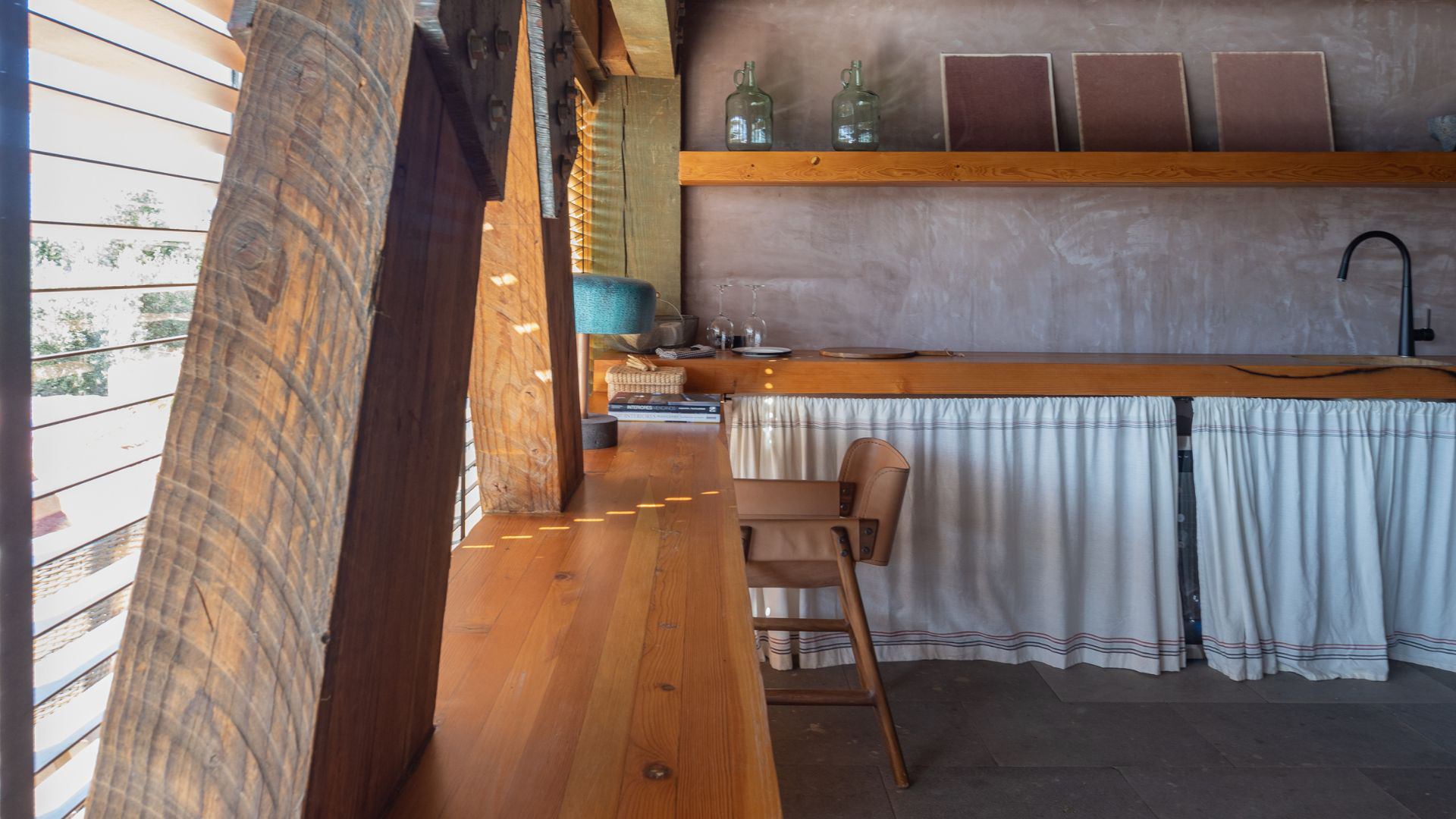 a table with a chair and a table with a white tablecloth