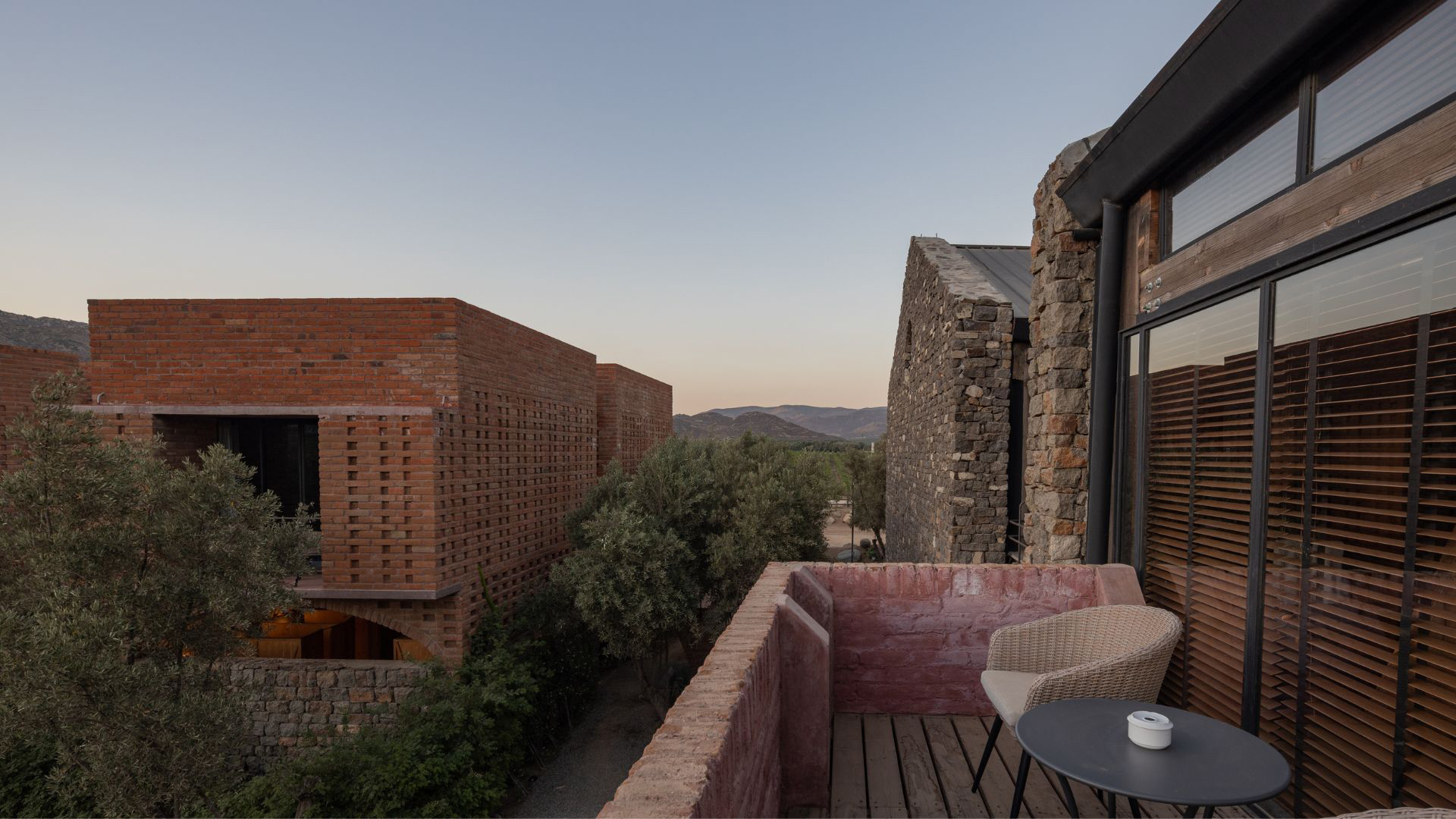 a patio with a table and chairs and brick buildings