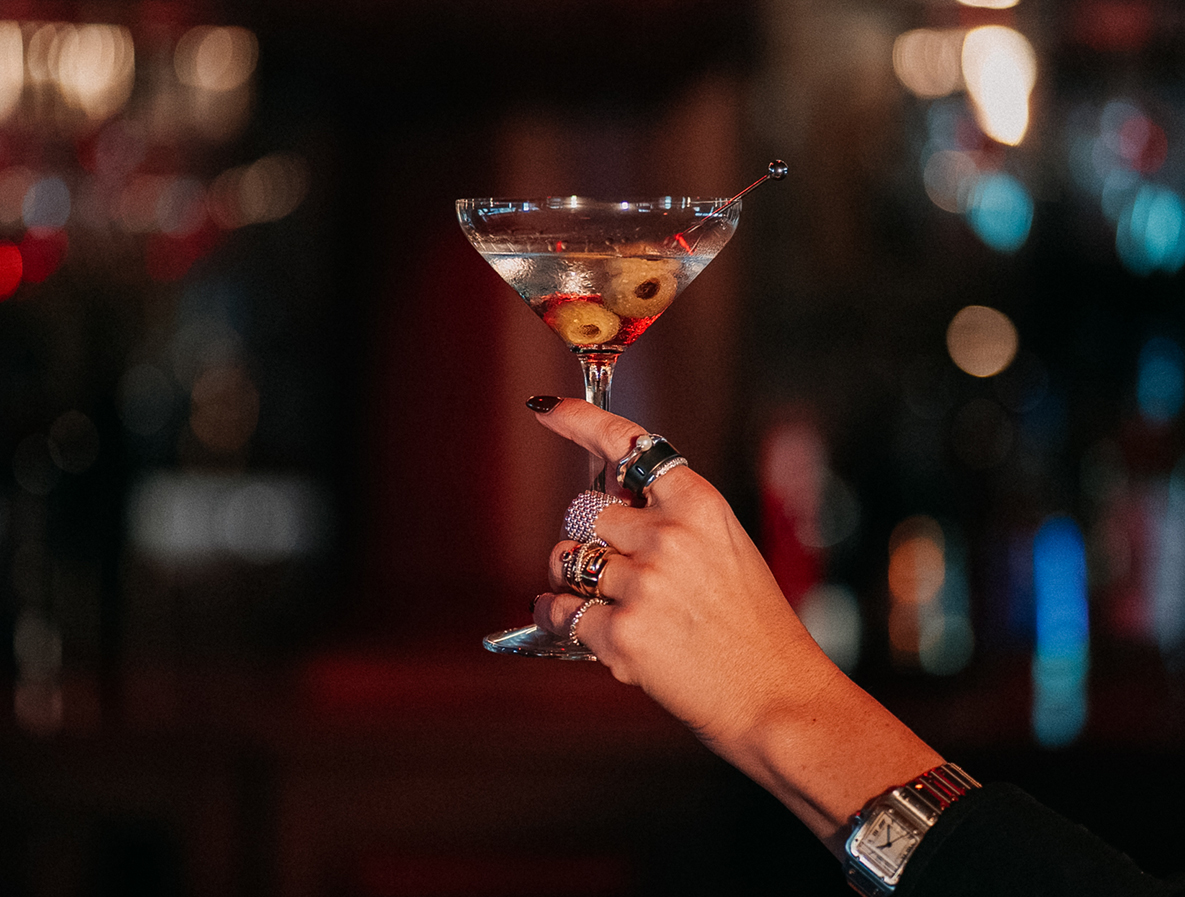 a hand holding a martini glass