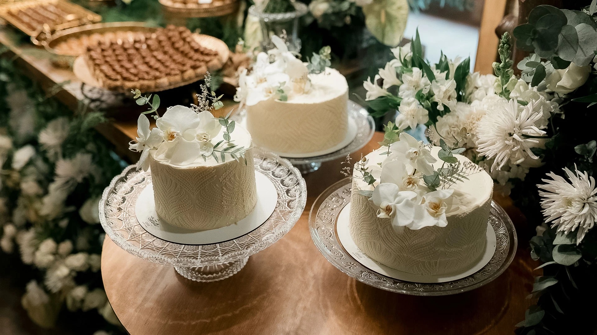 a group of cakes on plates with flowers