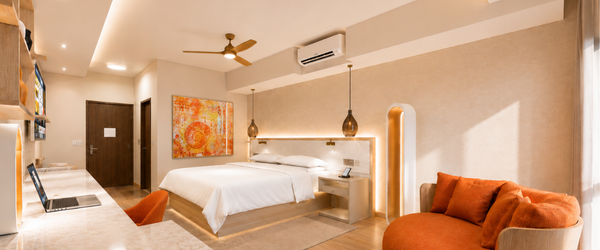 a room with a bed and a fan