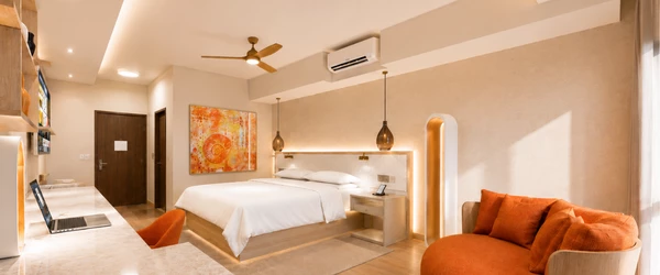 a room with a bed and a fan