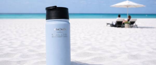 a white bottle on a beach