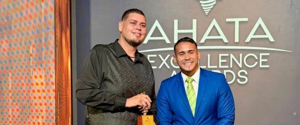 a man in a suit holding a trophy