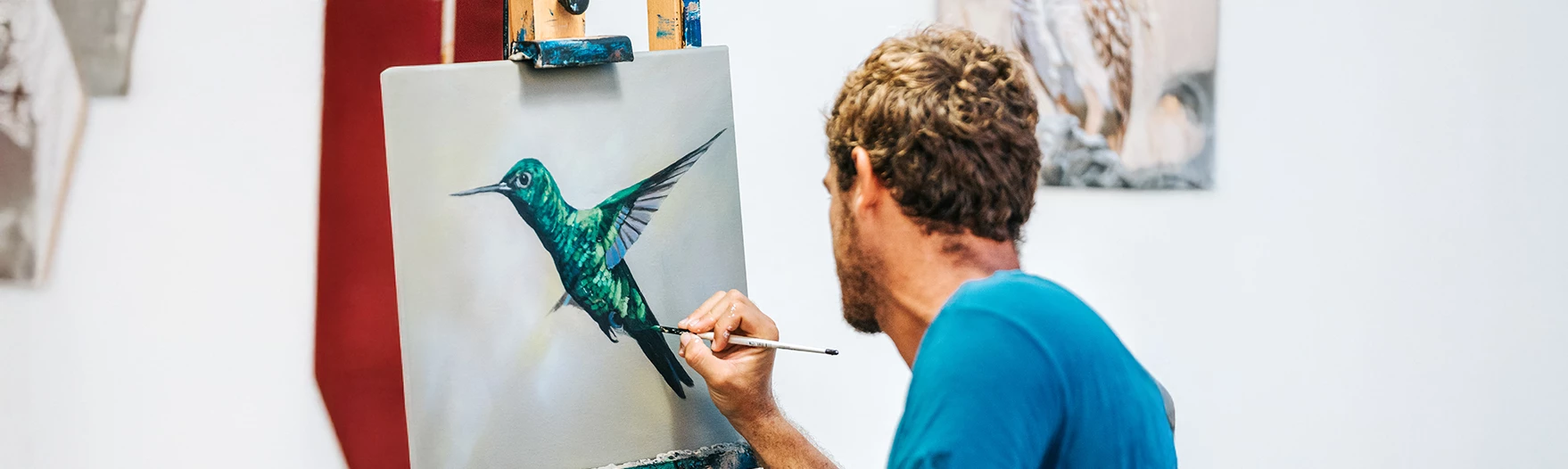 a man painting a bird