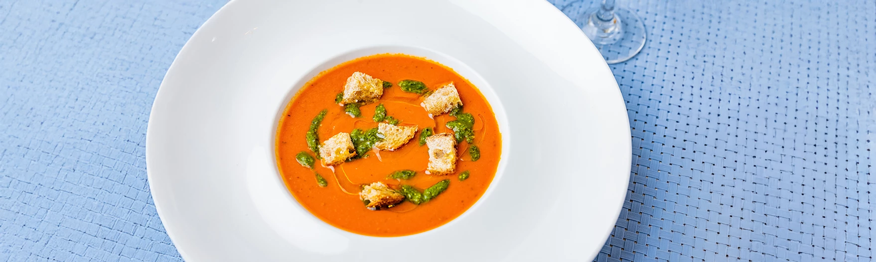 a bowl of soup with croutons