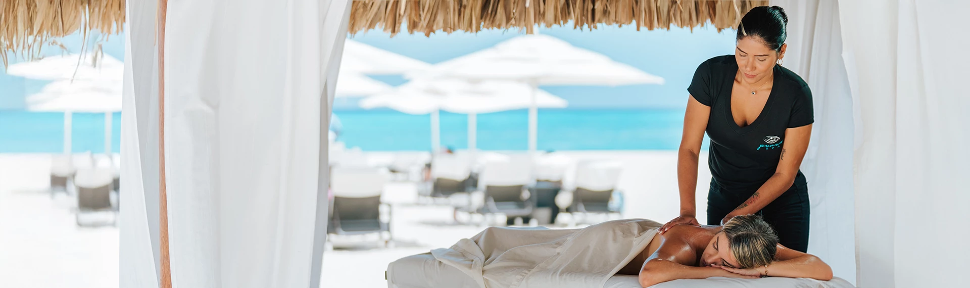 a person lying on a bed on a beach