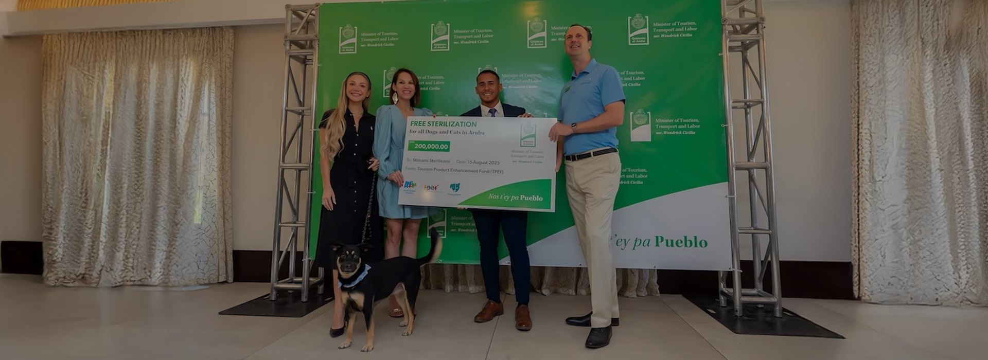 a group of people standing next to a large check