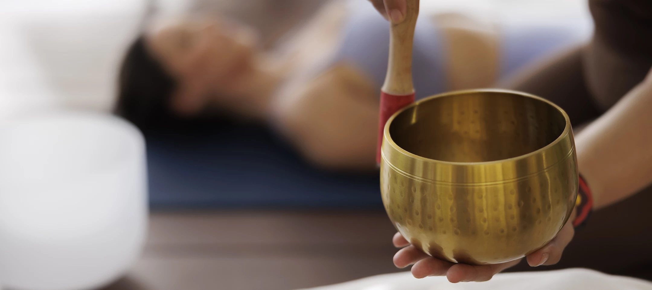 a person holding a brass bowl