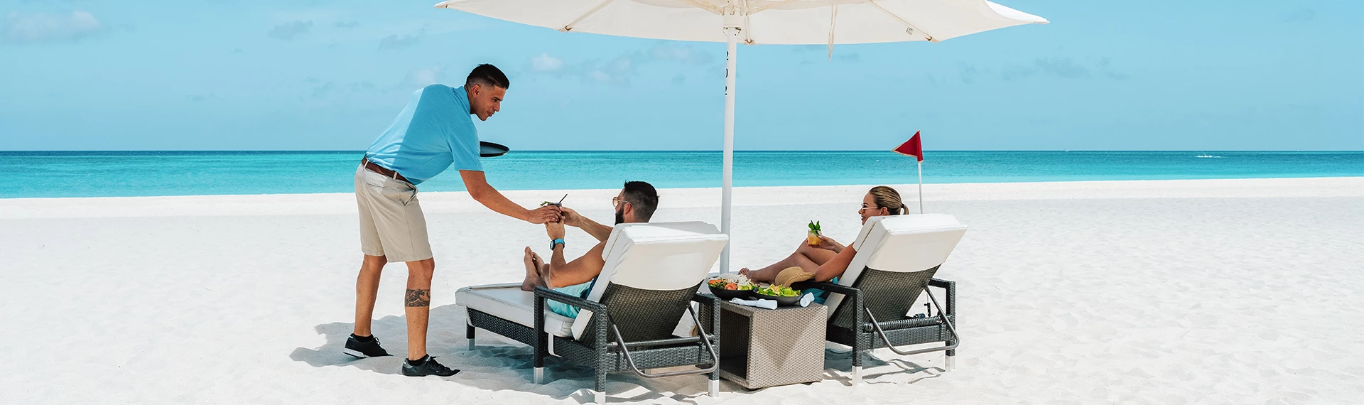 a man serving a woman on a beach