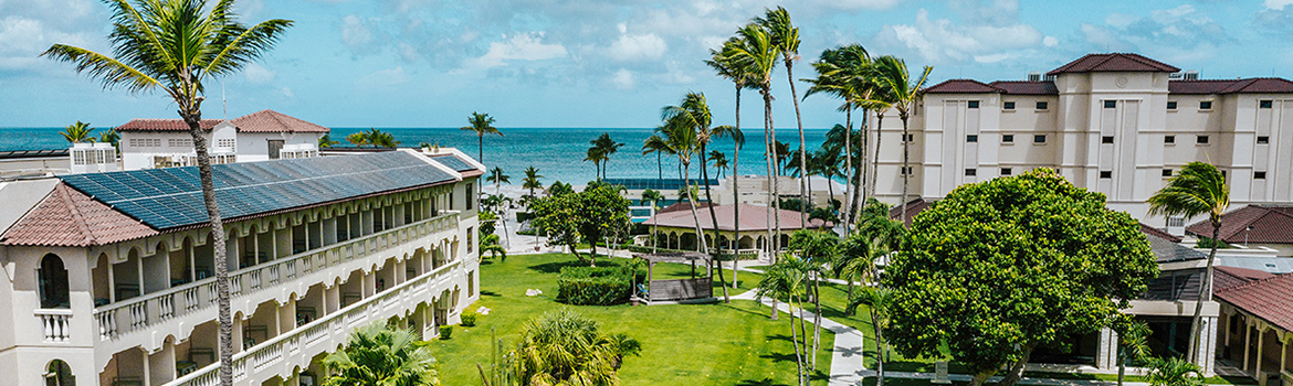 a building with palm trees and a beach