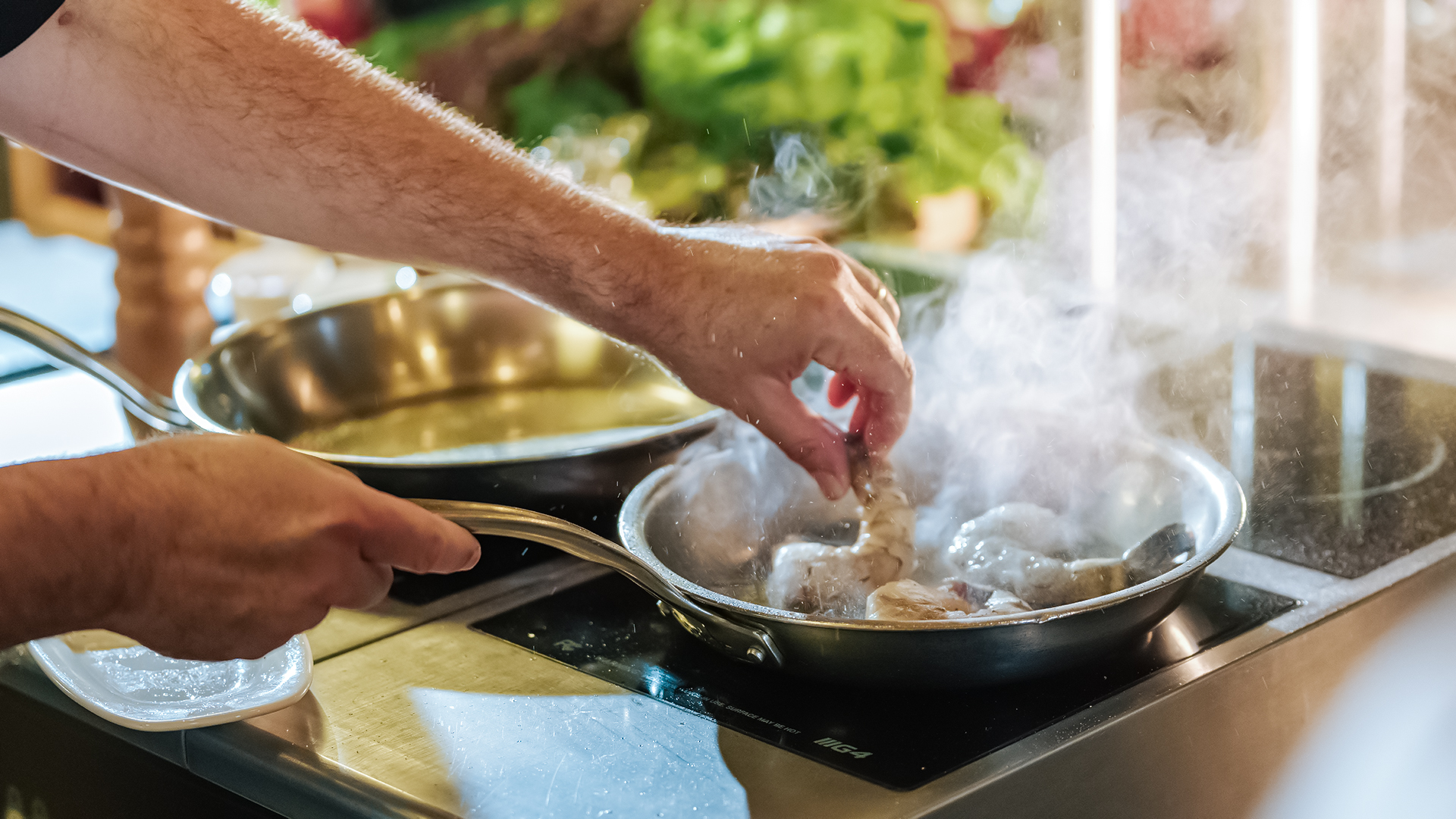 a person cooking food in a pan