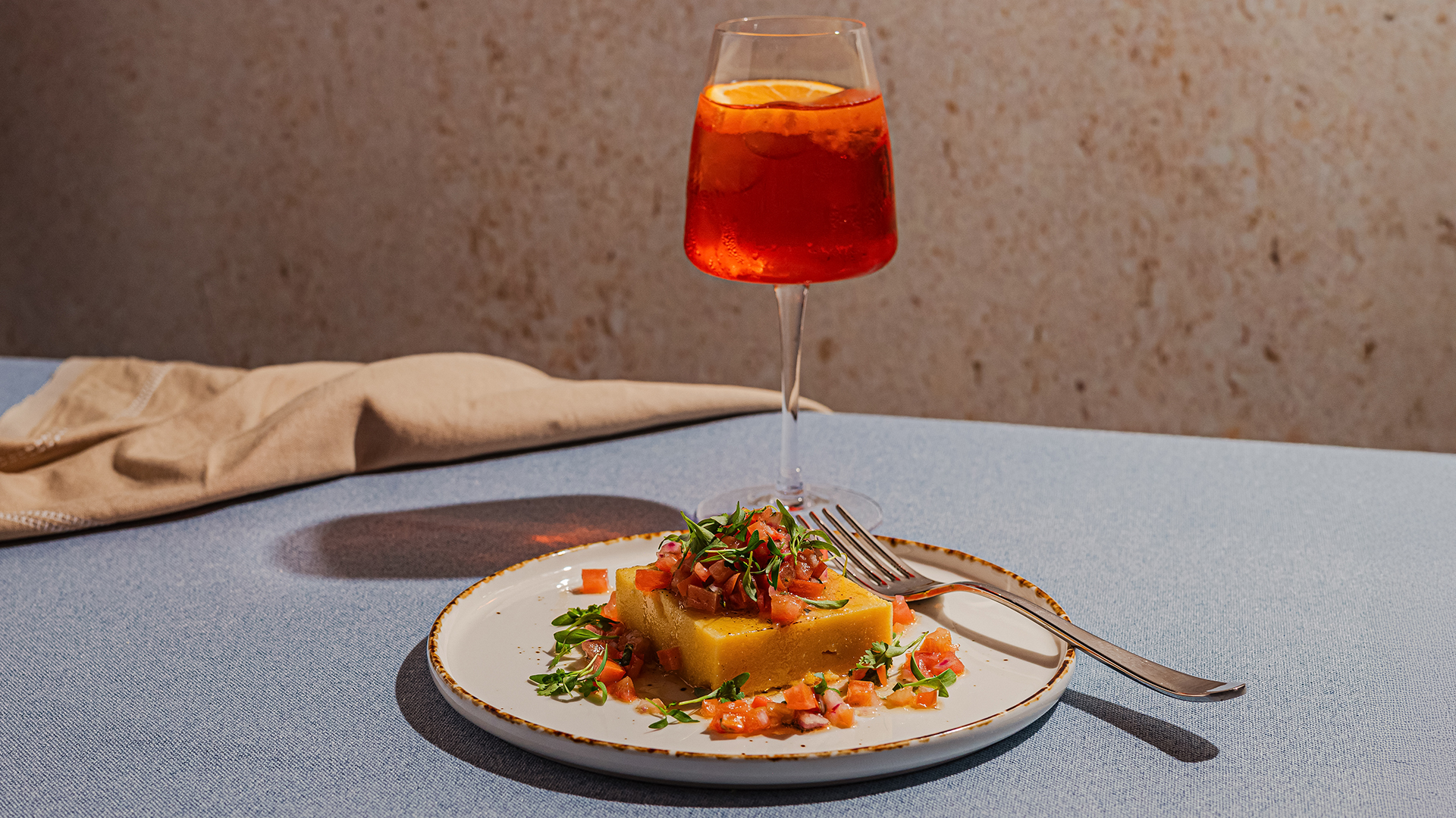 a plate of food and a glass of liquid
