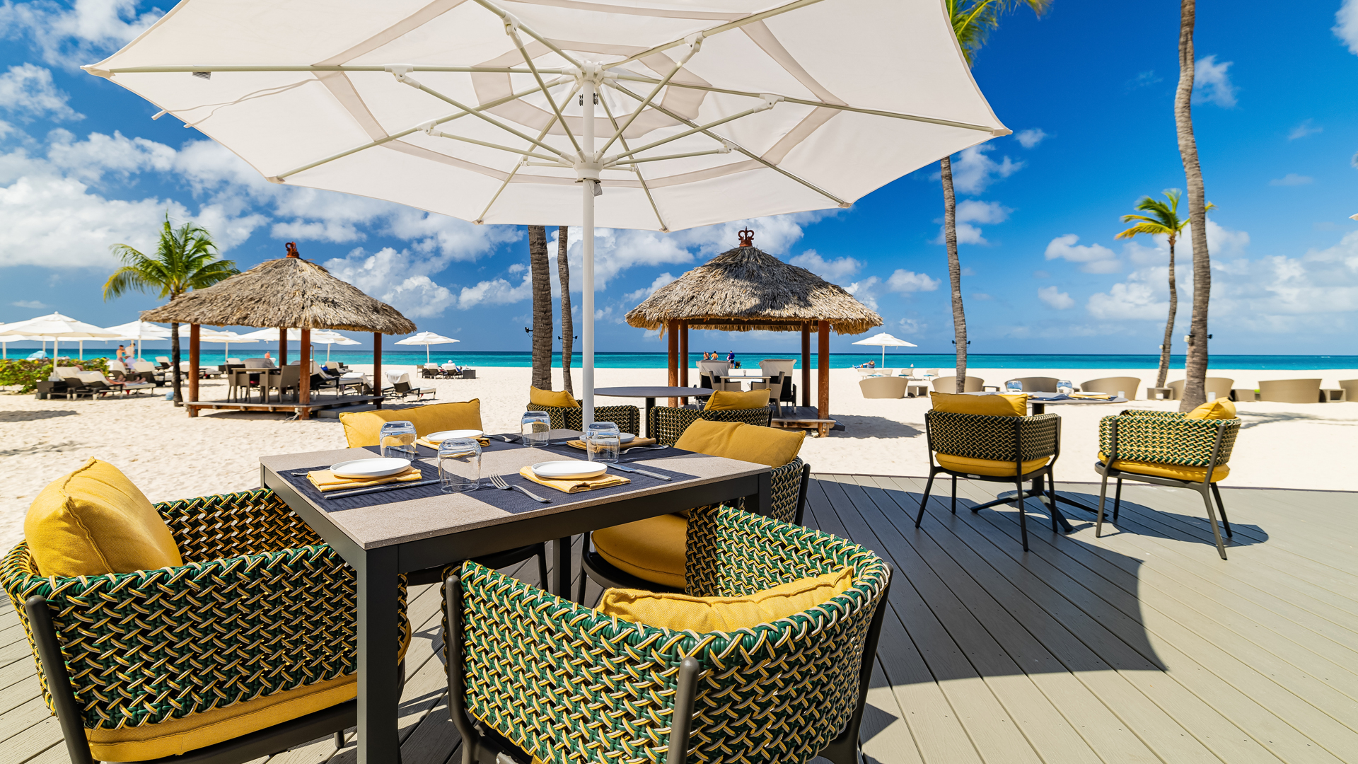 a table and chairs on a beach