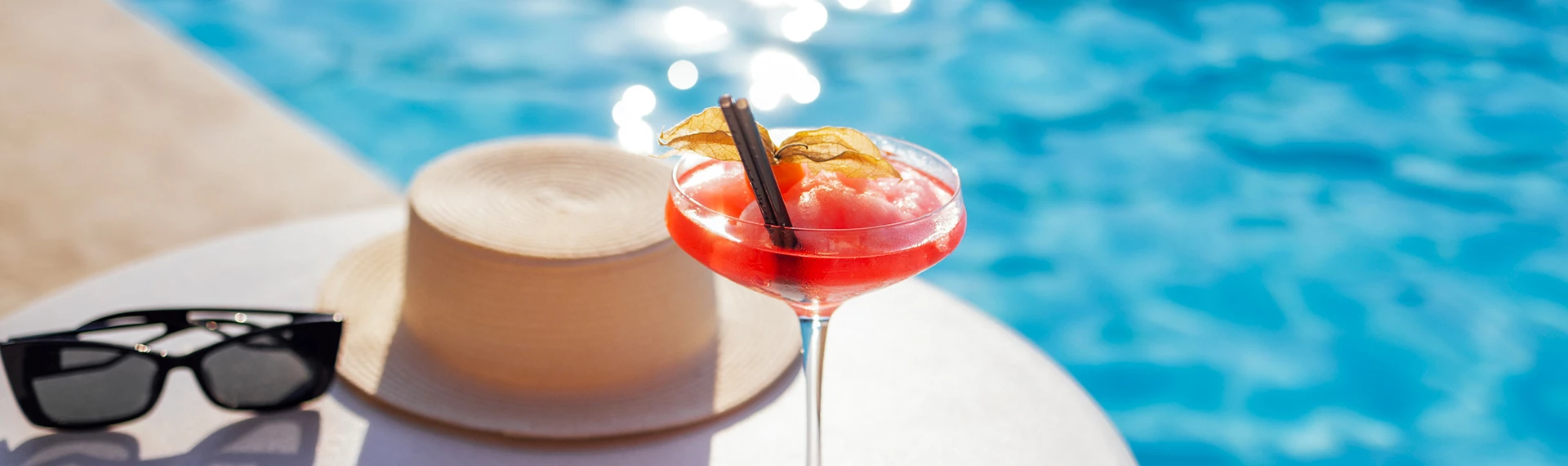a drink in a glass with straw and straw on a table