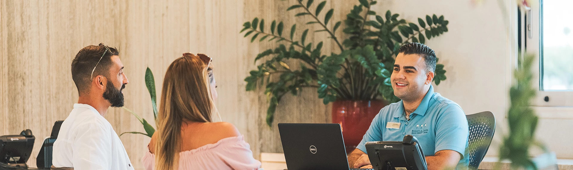 a man and woman sitting at a table with laptops