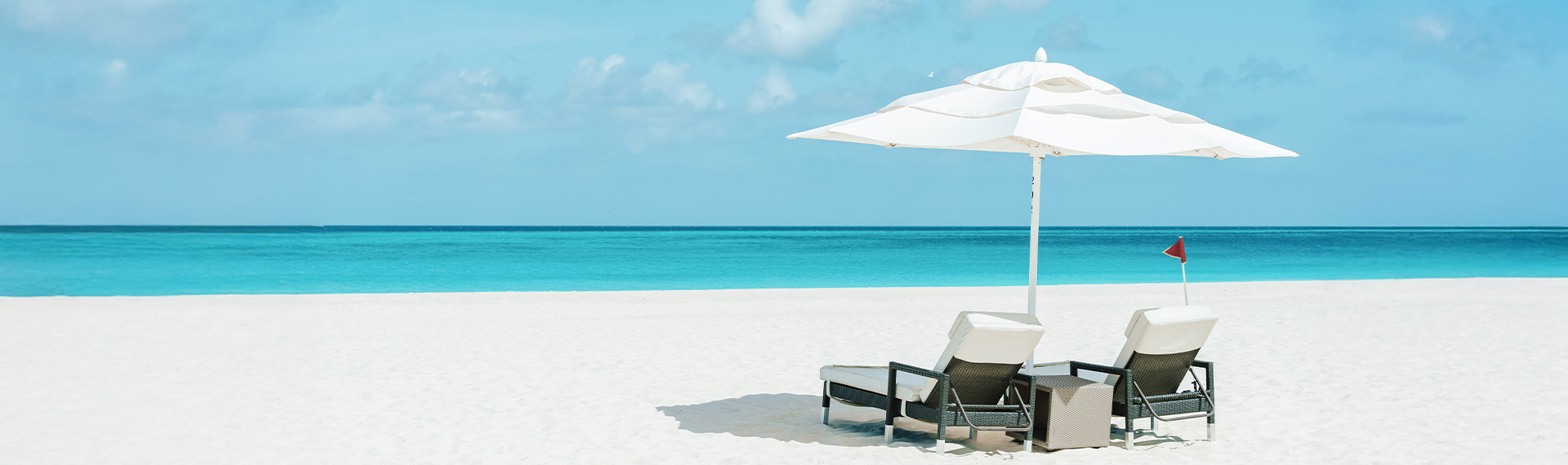 a beach chair and umbrella on a sunny day