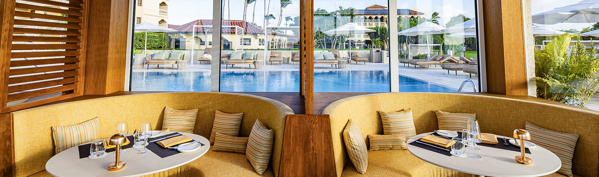 a couches and pillows in a room with a pool