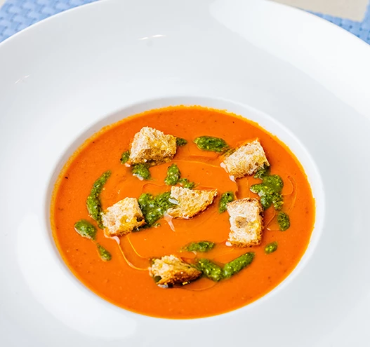 a bowl of soup with croutons