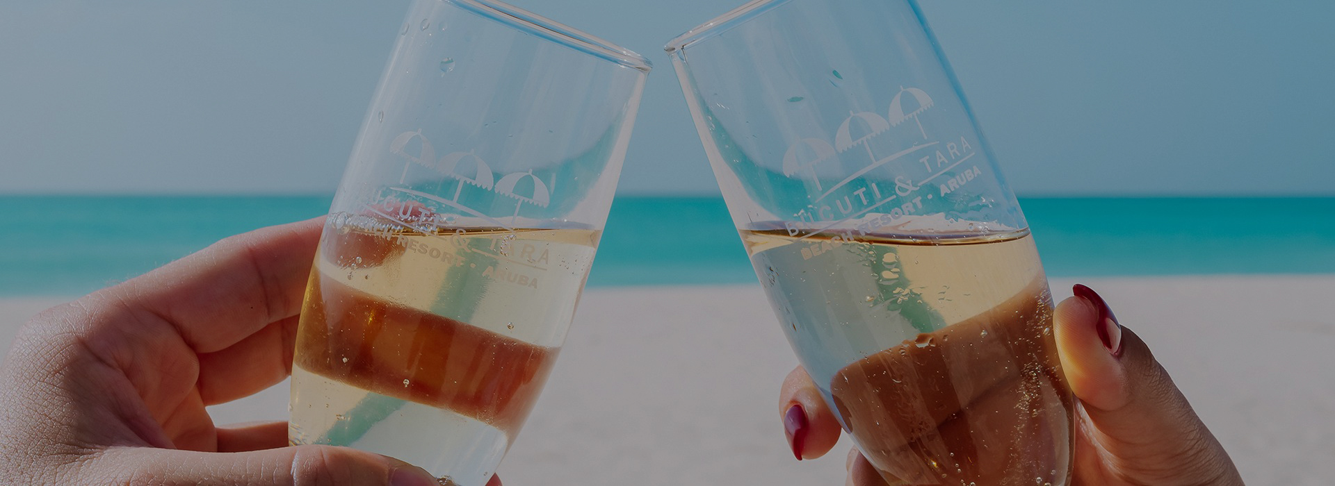 a pair of hands holding glasses with champagne