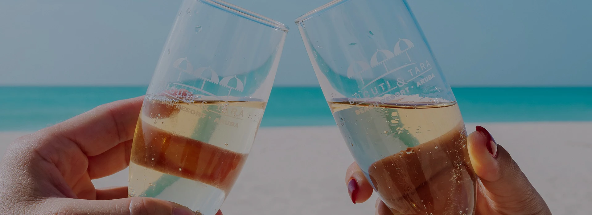 a pair of hands holding glasses with champagne