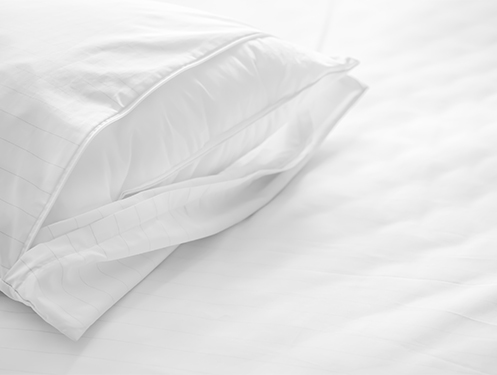 a white pillow on a bed