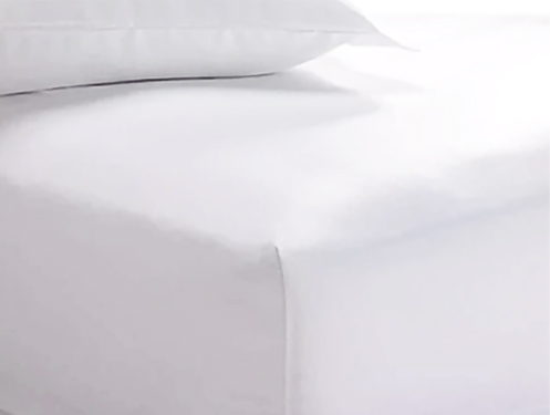 a white bed sheet and pillow