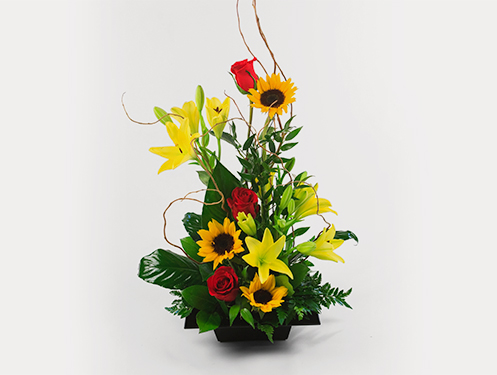 a bouquet of flowers in a black square container