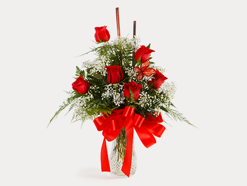 a vase of red roses and butterflies