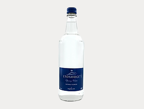 a clear bottle with a blue label