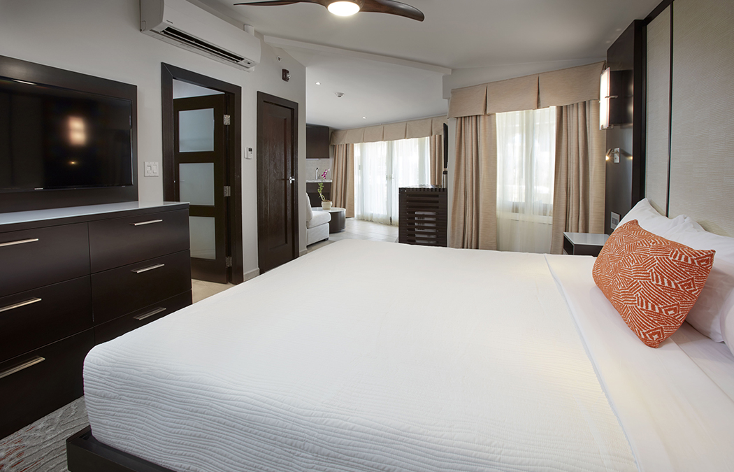 a room with a bed and a fan