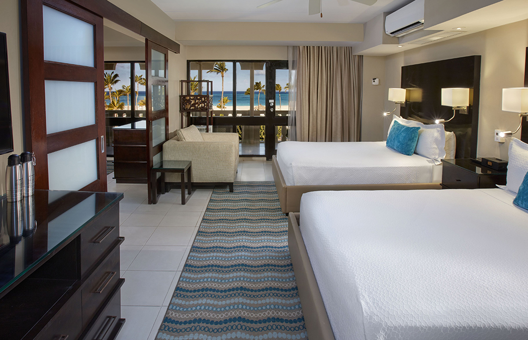 a room with two beds and a couch