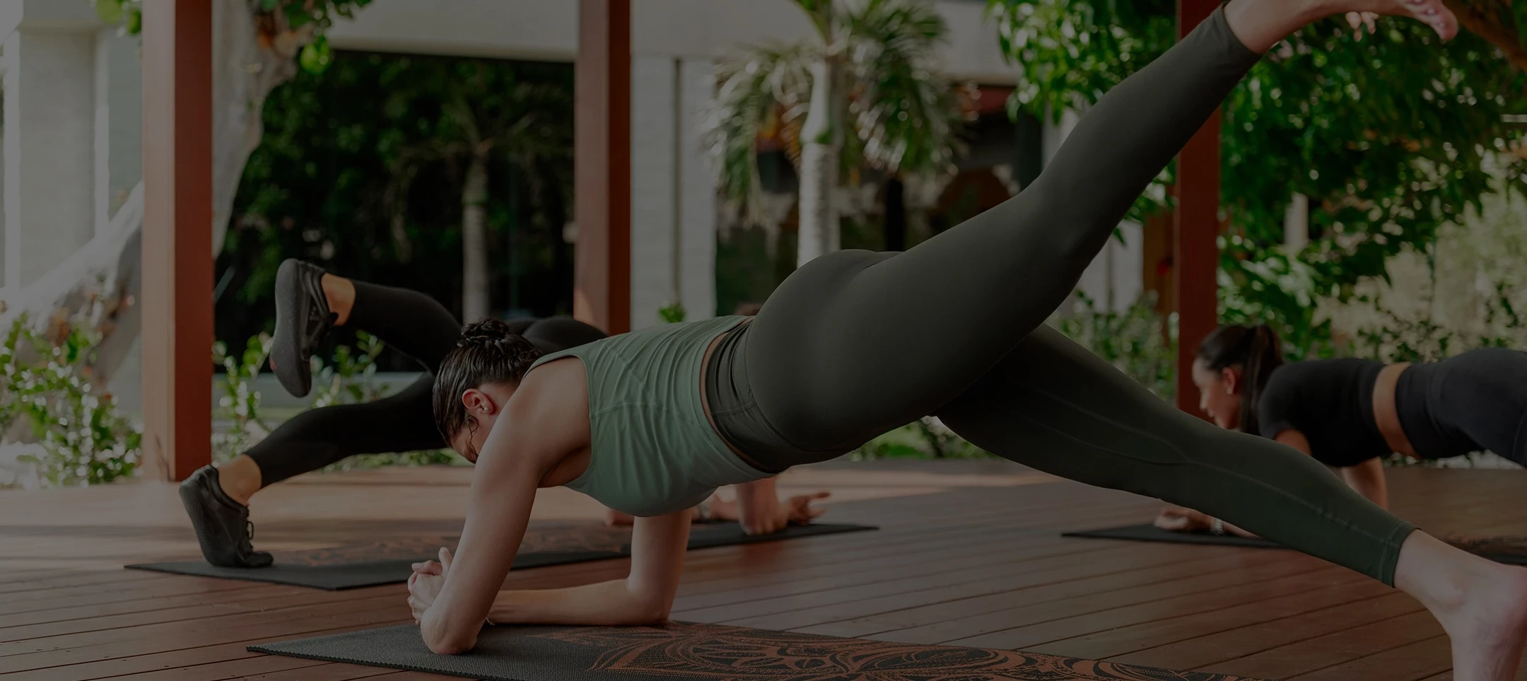 a woman doing yoga on mats