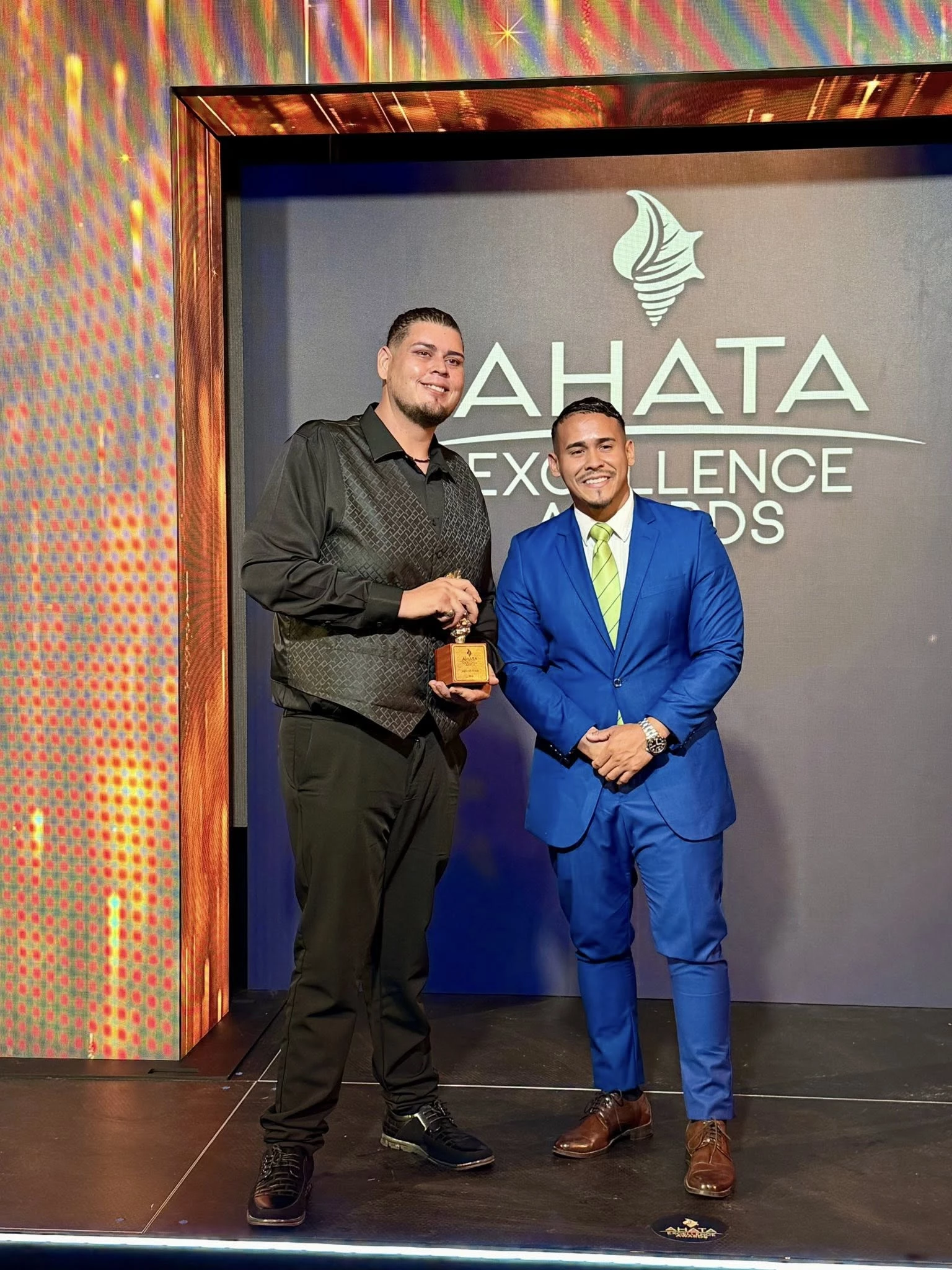 two men standing on a stage