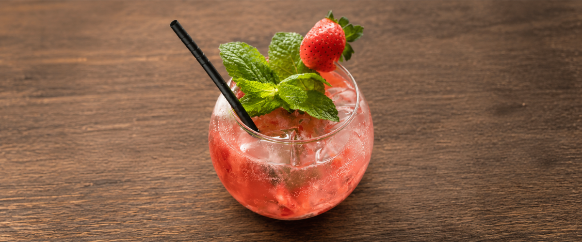 a glass with a drink and straw
