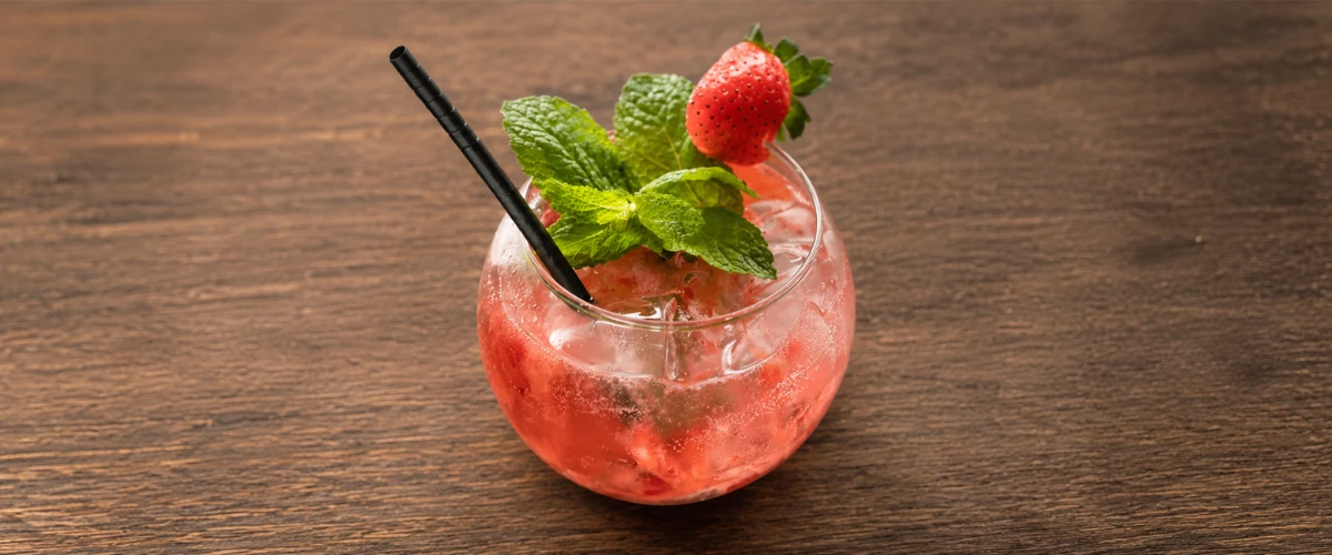 a glass with a drink and straw