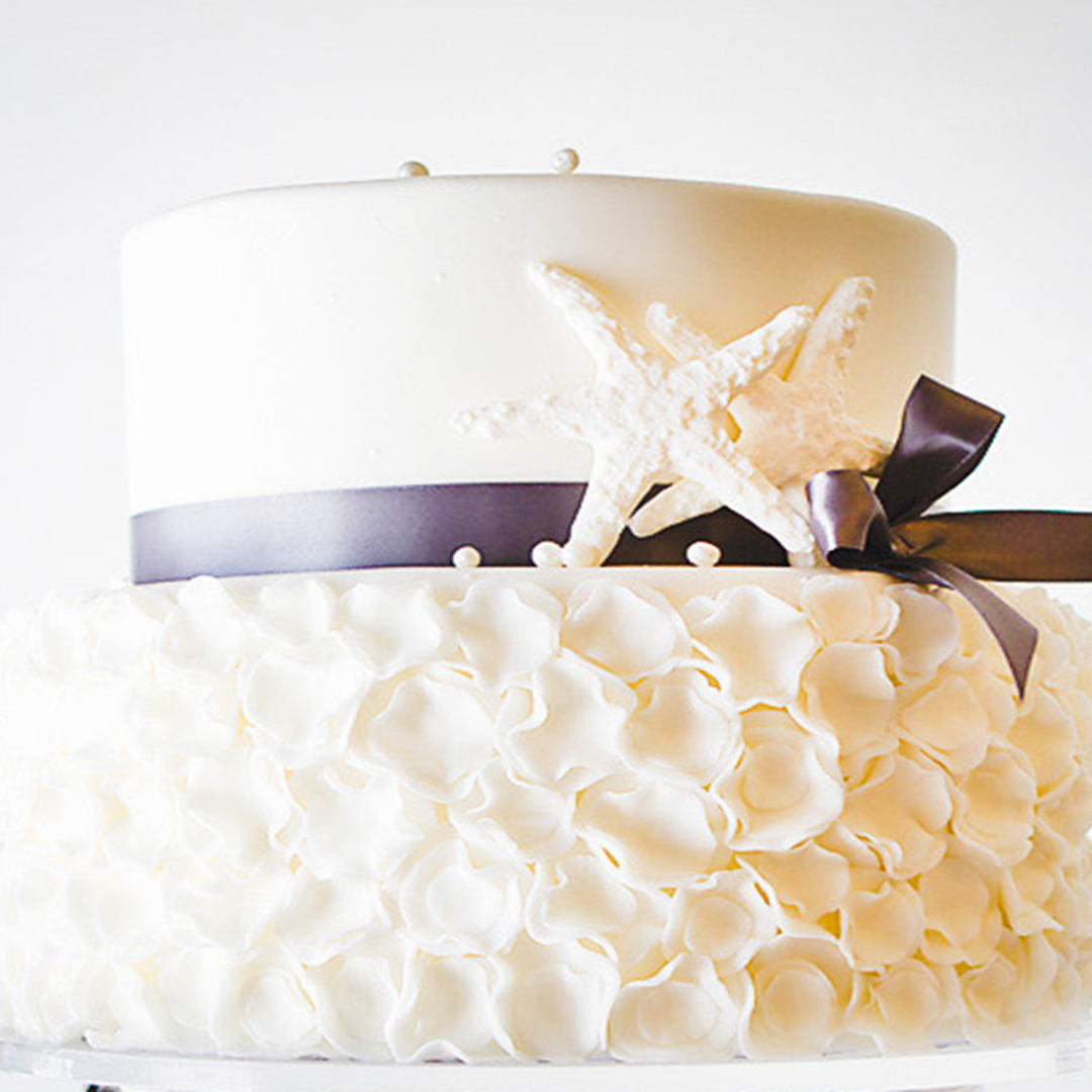 a white cake with a starfish on top