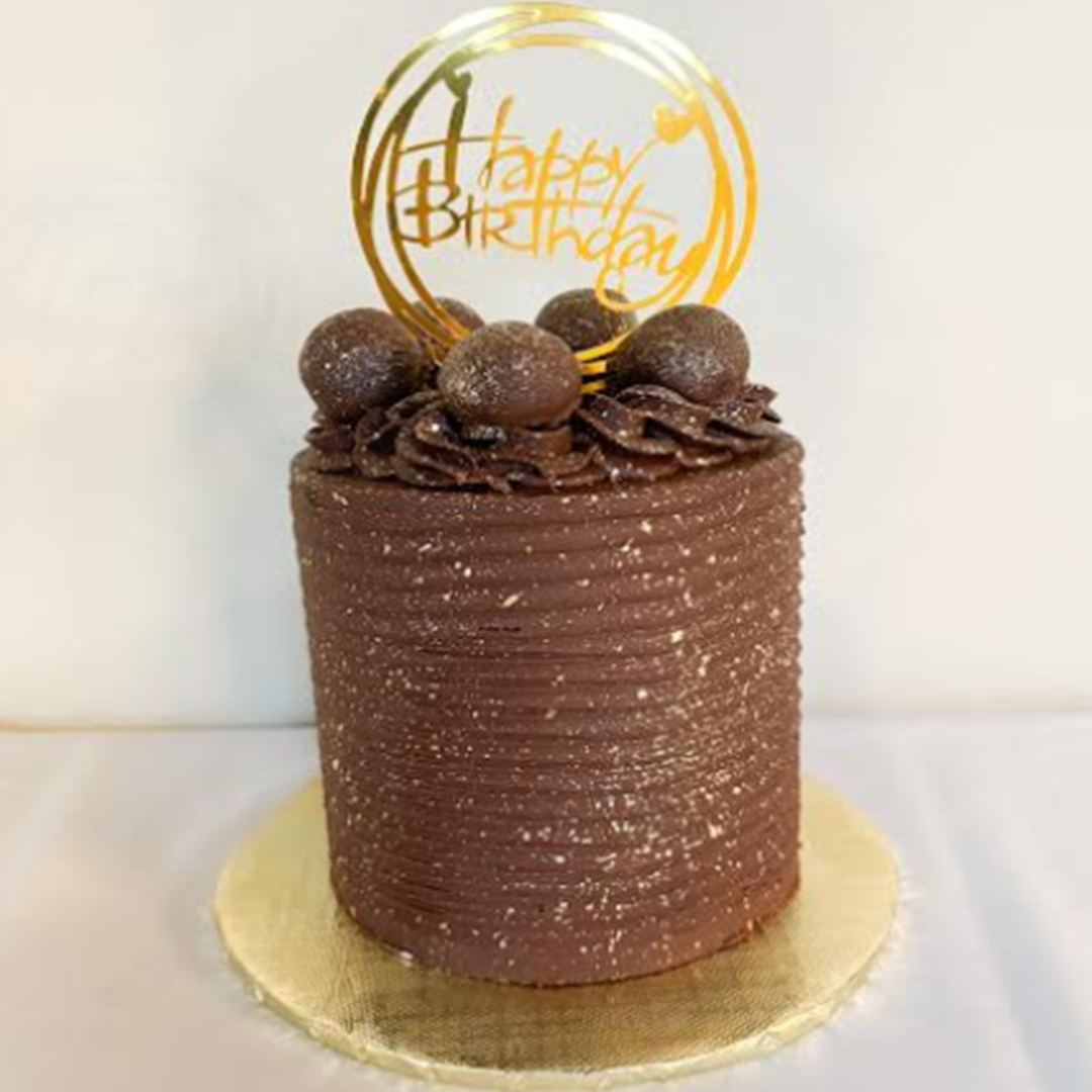 a chocolate cake with a happy birthday sign