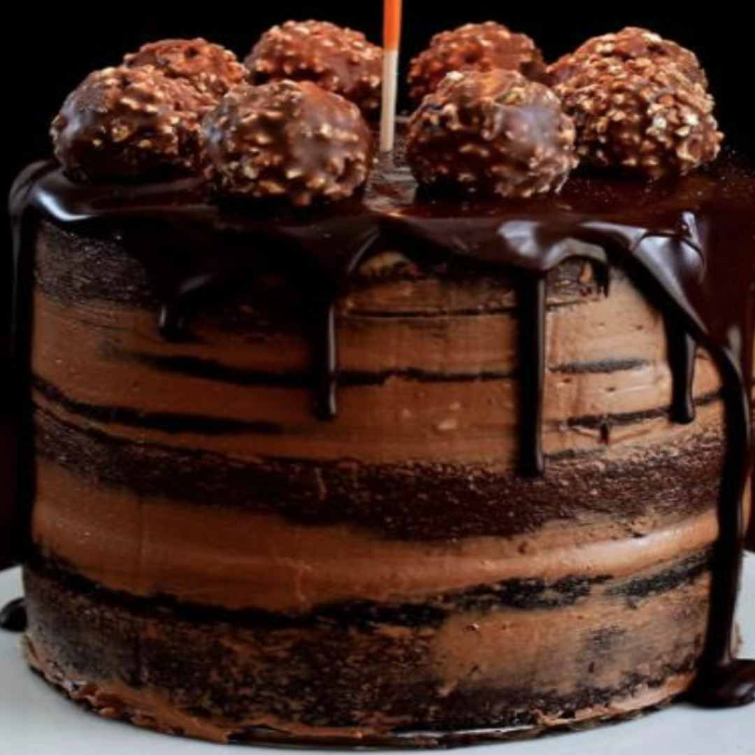 a chocolate cake with balls on top