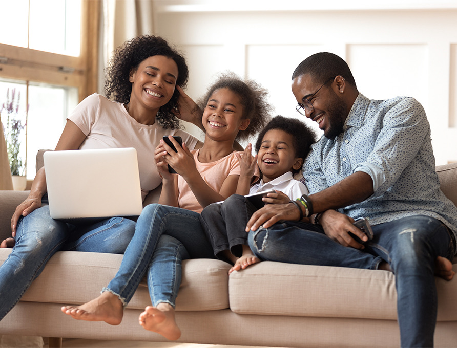 Family gathered together on a beige couch