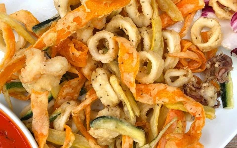 seafood fried dish with a dressing on the side