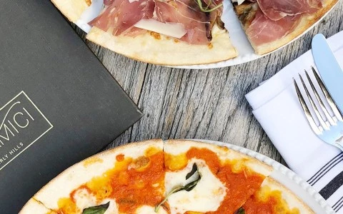 two different type of Amici pizzas served in the table 