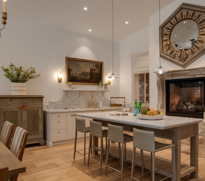 a kitchen with a fireplace and a table