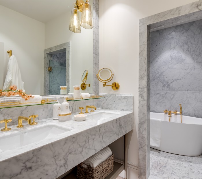 a bathroom with marble counter tops and a tub