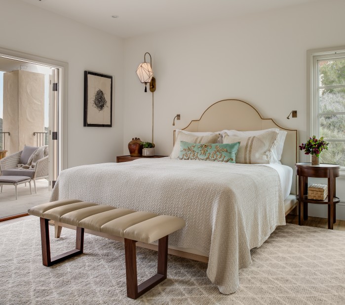 a bedroom with a bed and a bench