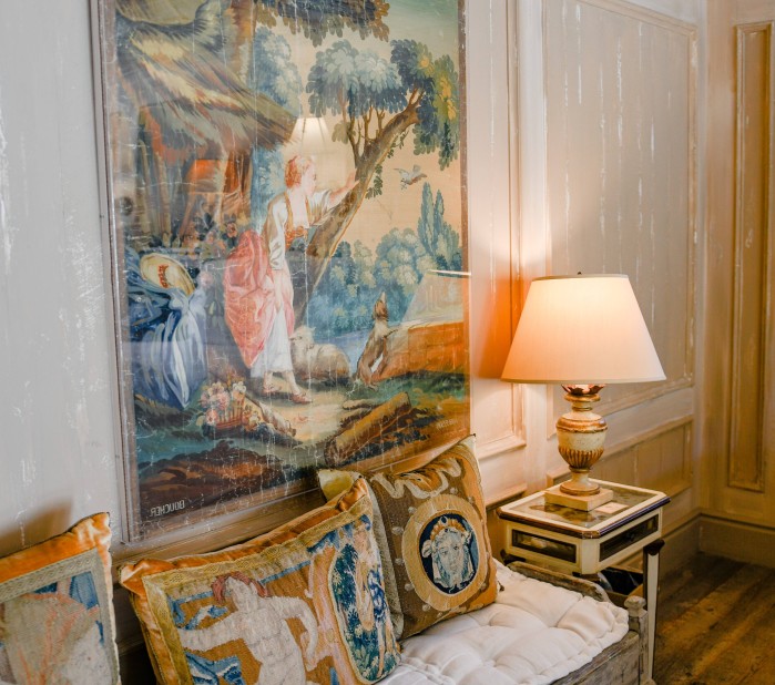 a couch with pillows and a lamp in a room