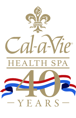 a black sign with gold text and red white and blue ribbon